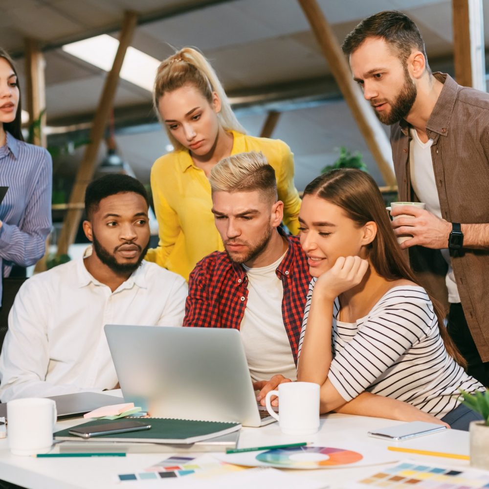 Freelance web designers brainstorming together in office